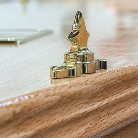 Brass lid fitting on the solid oak lid moulding of The Haddon, showing the high gloss finish